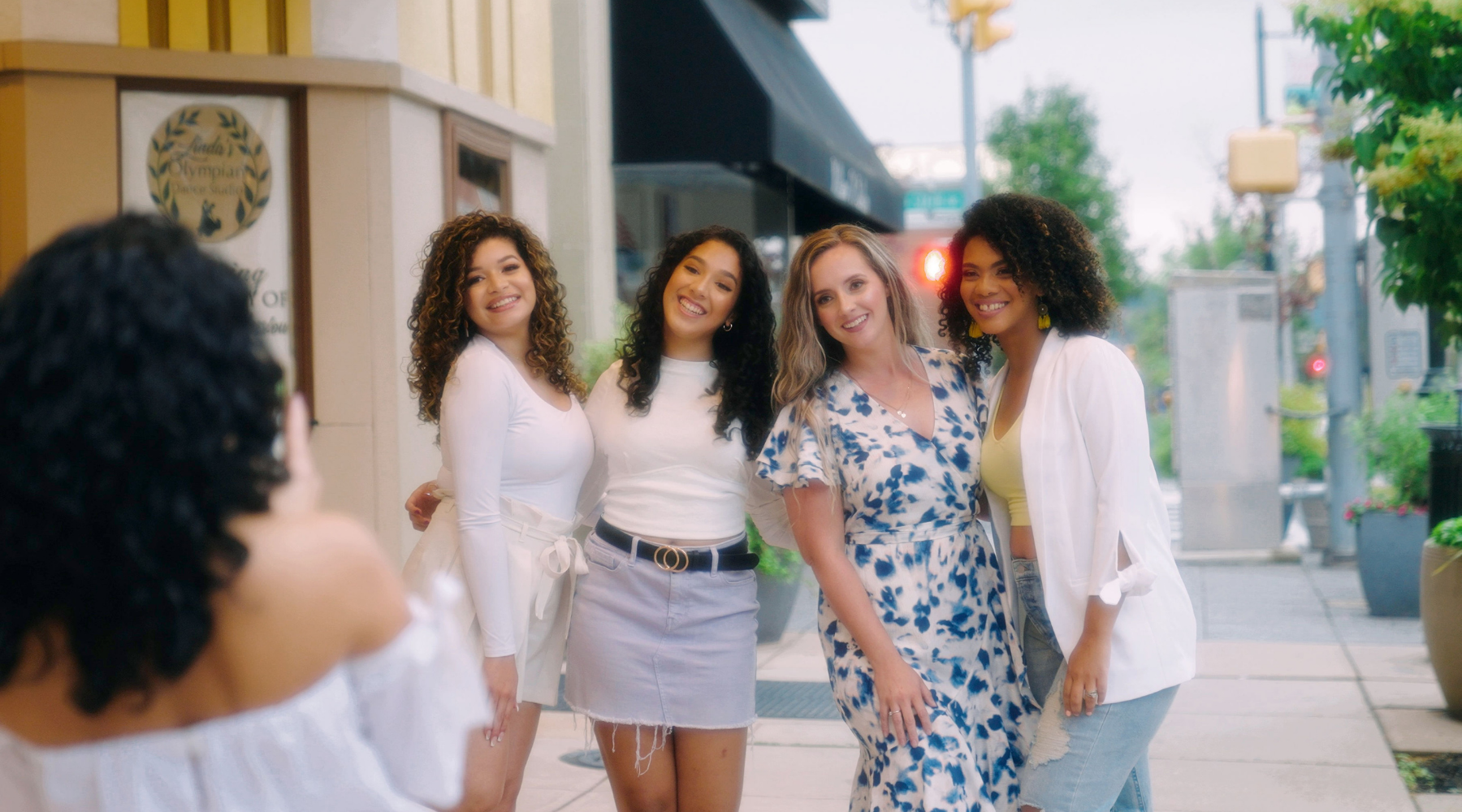 Four curly girls getting their picture taken