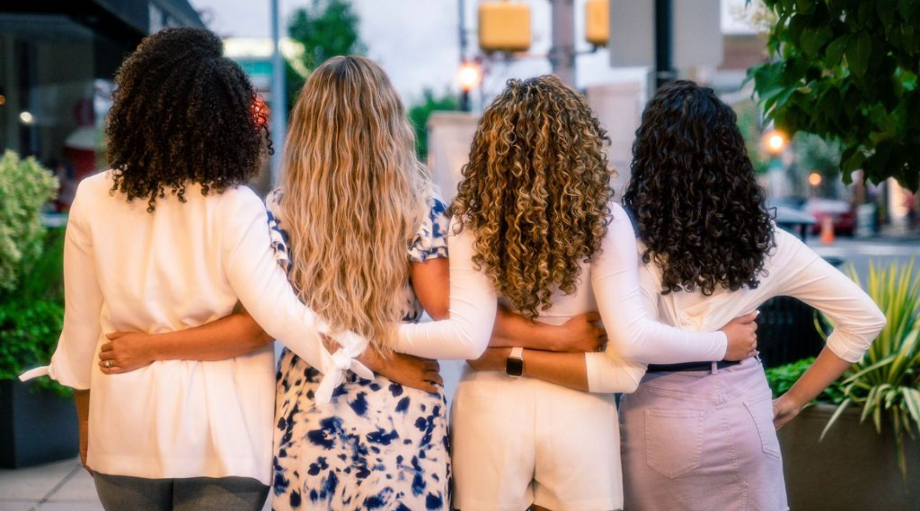 Hair texture shot of four curly women