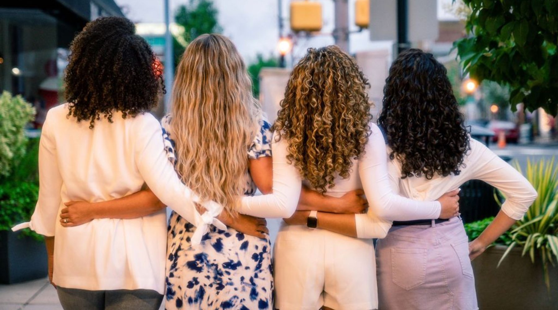 Hair texture shot of four curly women 